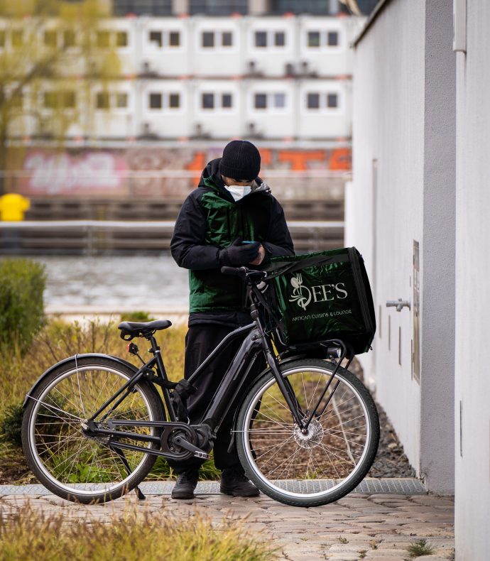 A Dee's rider with an insulated delivery box on a bicycle
